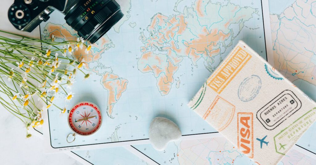 Flat lay of travel essentials: maps, camera, compass, and travel journal for planning adventures.